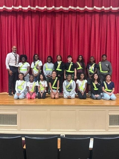Principal Dr. Cordero stands with Grover Cleveland Elementary's newly sworn-in Safety Patrol team for the 2026-27 school year.
