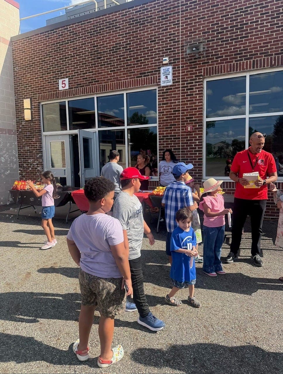 Students and families enjoy activities at the Grover Cleveland Elementary School welcome event.