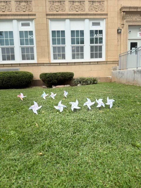 Student-made pinwheels line the front lawn at Grover Cleveland School in Rahway.