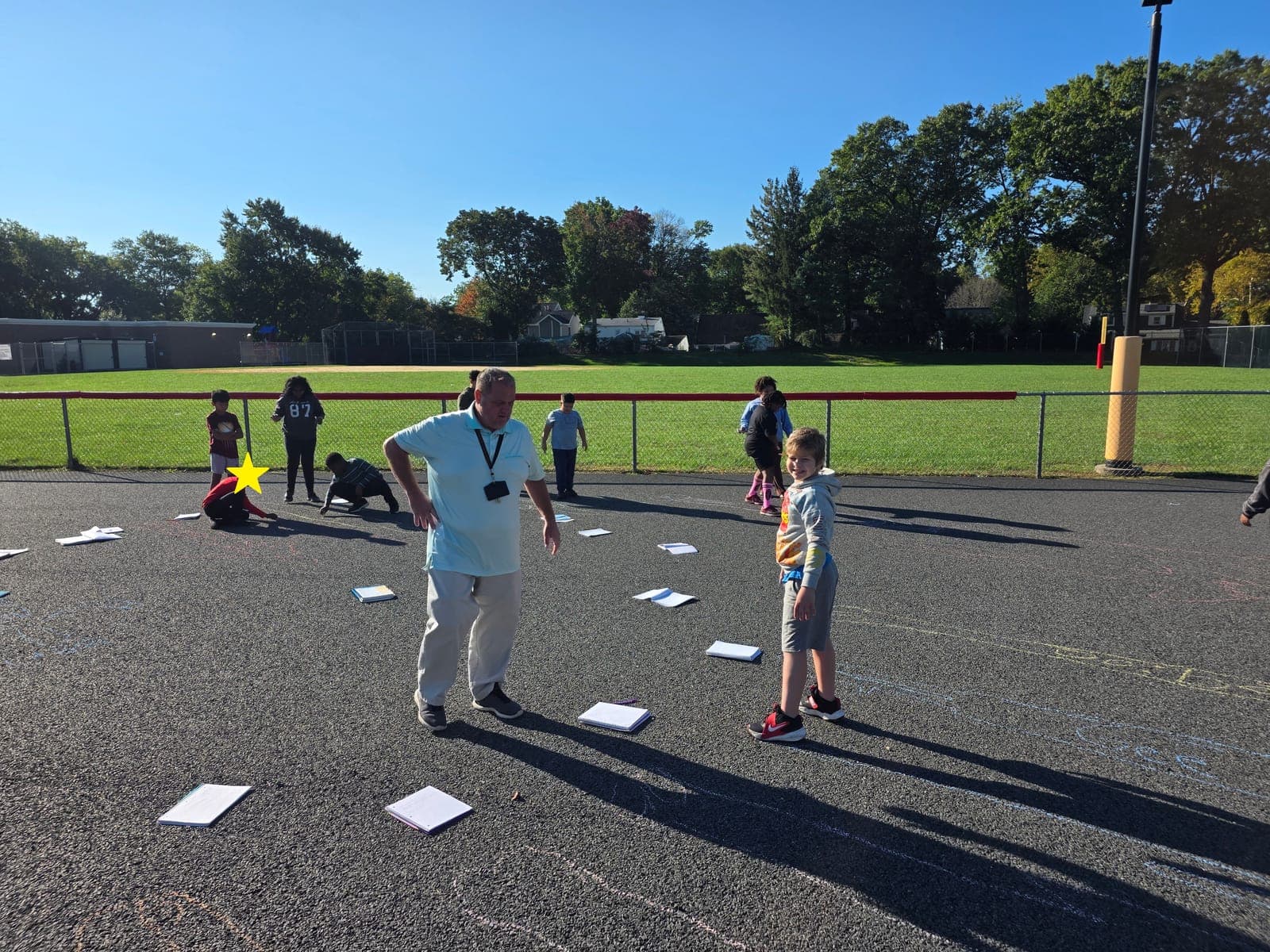 Students take their science lessons outdoors to observe and track shadows.